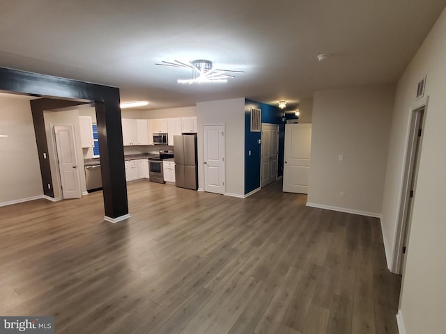 unfurnished living room with dark hardwood / wood-style floors