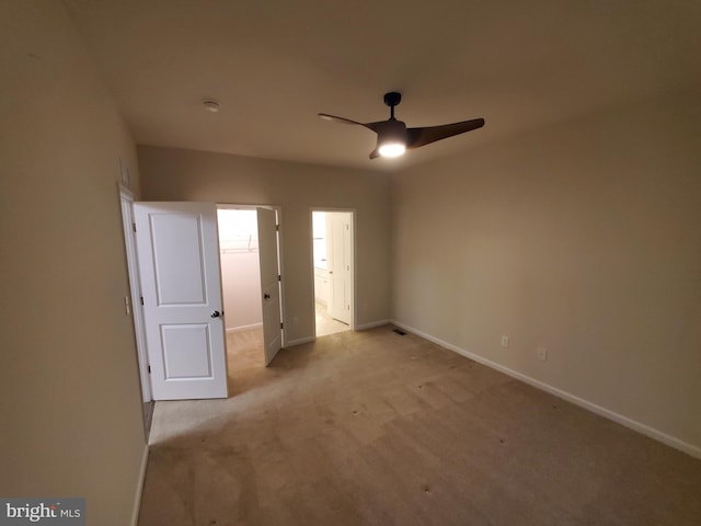 unfurnished bedroom featuring ceiling fan and light colored carpet