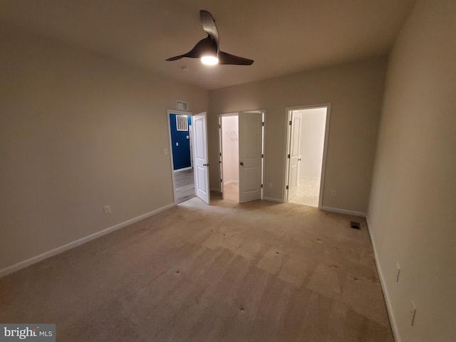 unfurnished bedroom featuring ceiling fan and light colored carpet