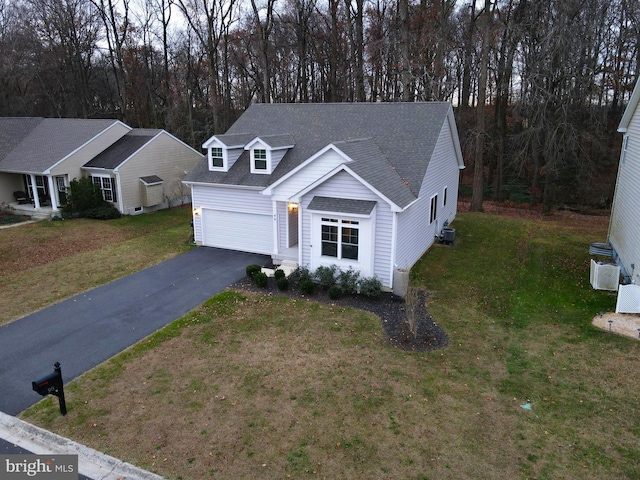 view of front of property with a front yard and a garage