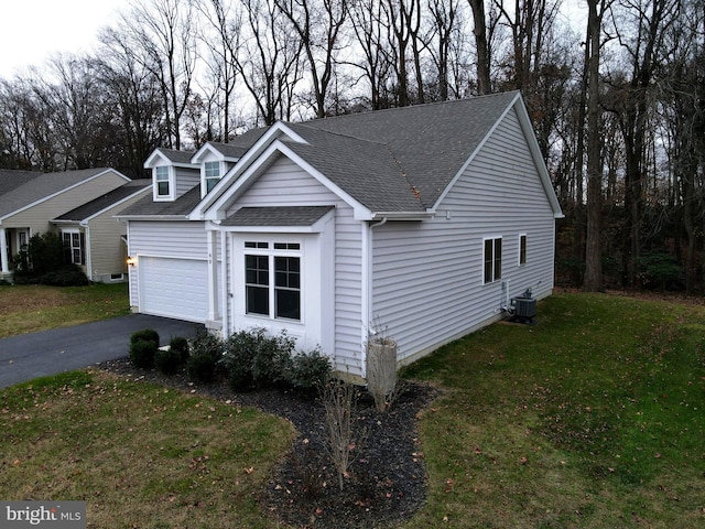 view of side of property with a lawn and central air condition unit