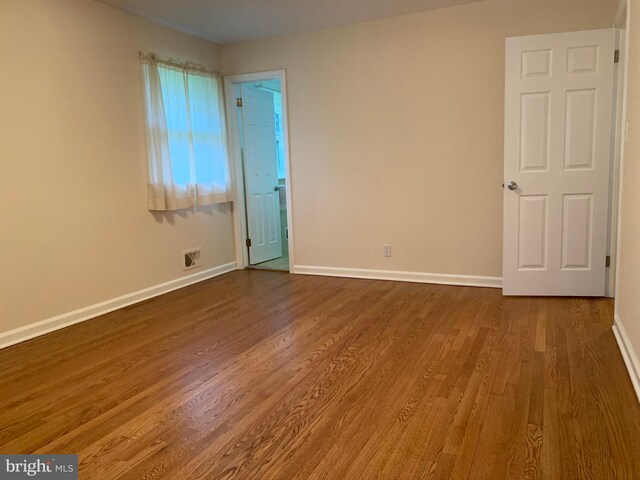 spare room featuring hardwood / wood-style floors