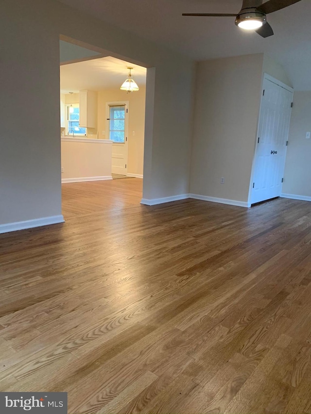 empty room with ceiling fan and hardwood / wood-style floors