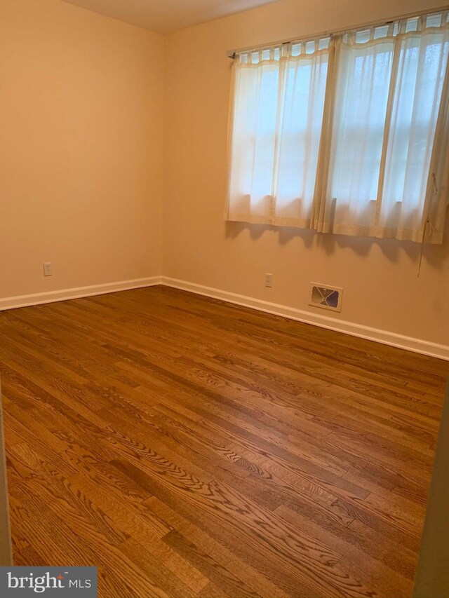 spare room featuring hardwood / wood-style floors