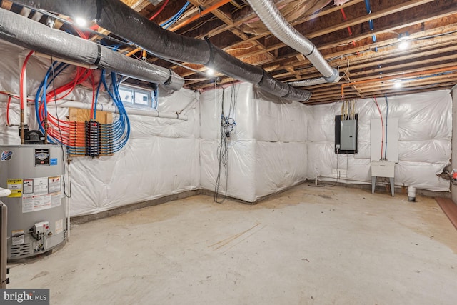 basement featuring electric panel and water heater