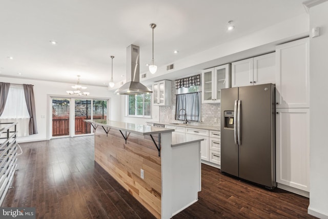 kitchen featuring stainless steel refrigerator with ice dispenser, island range hood, white cabinets, dark hardwood / wood-style floors, and a kitchen island