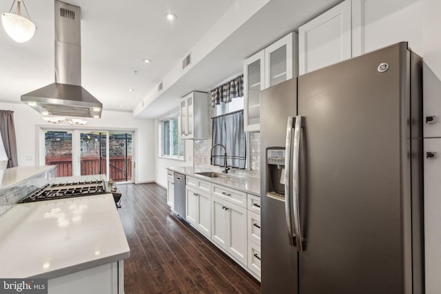 kitchen featuring dark wood-type flooring, sink, wall chimney exhaust hood, white cabinetry, and stainless steel appliances