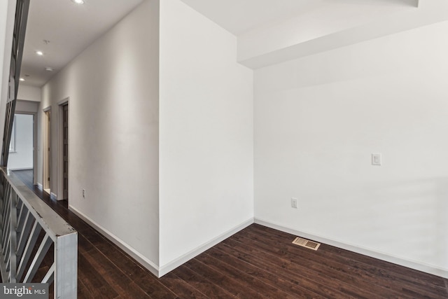 corridor with dark wood-type flooring