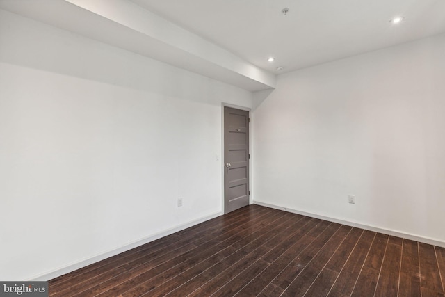 spare room featuring dark hardwood / wood-style floors