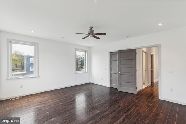 unfurnished bedroom featuring ceiling fan and dark wood-type flooring