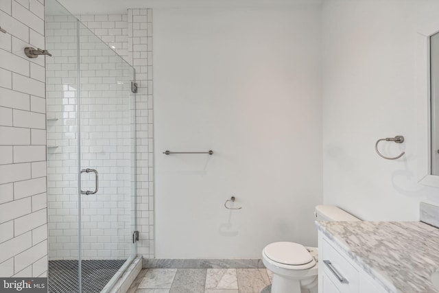 bathroom featuring vanity, toilet, and an enclosed shower