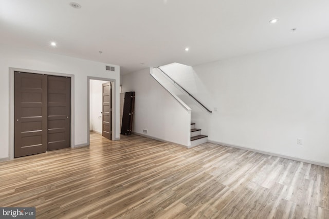 unfurnished living room featuring wood-type flooring