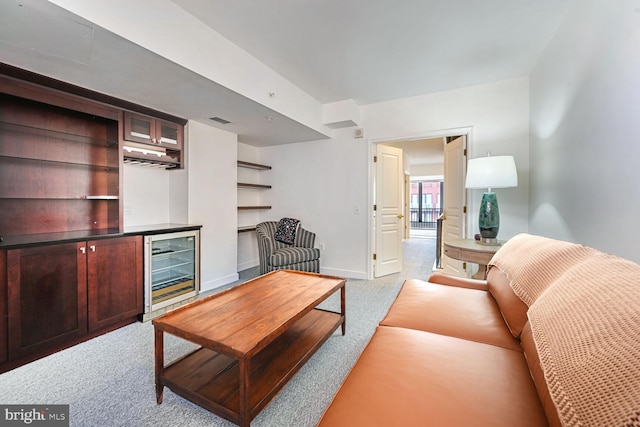 carpeted living room featuring bar and wine cooler