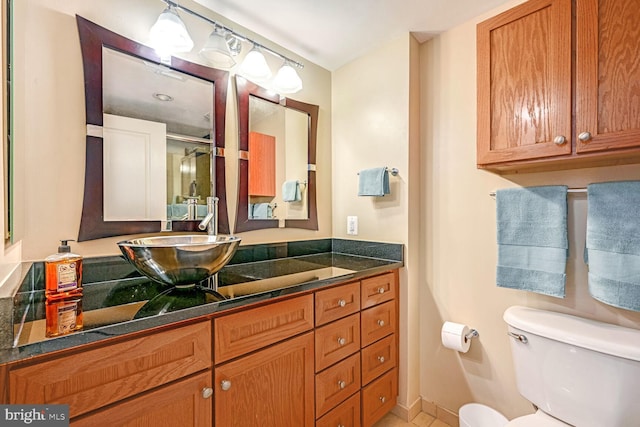 bathroom featuring vanity, toilet, and an enclosed shower