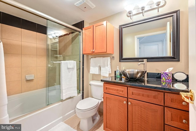 full bathroom with enclosed tub / shower combo, vanity, toilet, and tile patterned flooring