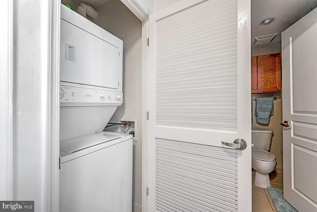 616 E NW Unit 1150, Washington, DC 20004 - washroom featuring stacked washer / dryer, light tile patterned floors, and recessed lighting