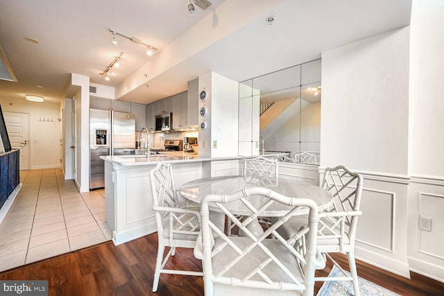 616 E NW Unit 1150, Washington, DC 20004 - dining space with wood finished floors, a decorative wall, and rail lighting
