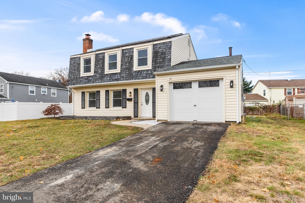 view of front of house with a garage and a front lawn