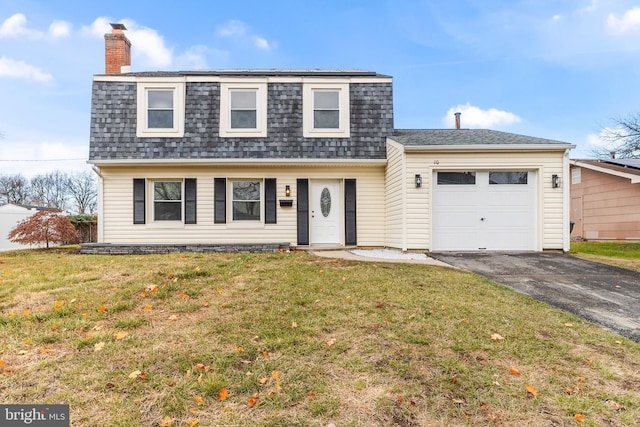 view of front property with a garage and a front yard