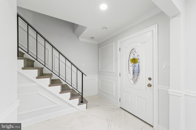 foyer entrance featuring crown molding