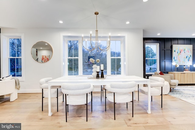 dining area with a chandelier and light hardwood / wood-style flooring