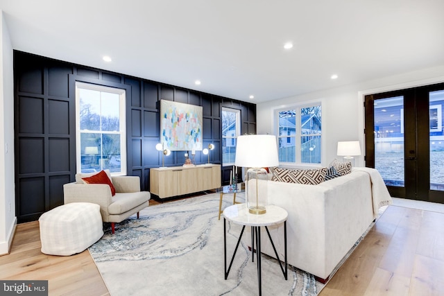 living room with light hardwood / wood-style flooring and french doors