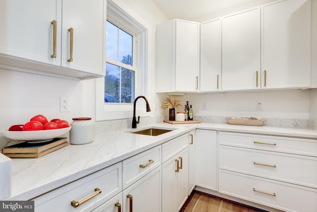 kitchen with white cabinetry and sink