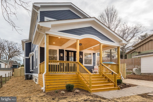 view of front of house featuring cooling unit and a porch