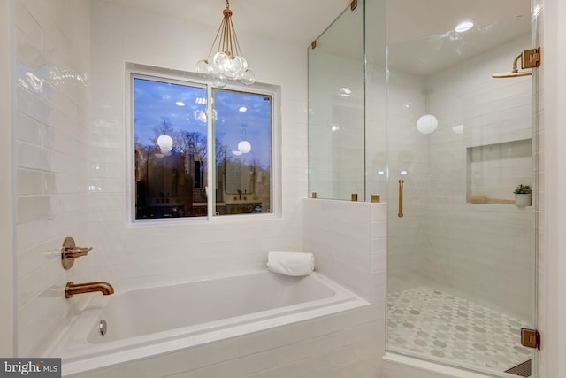 bathroom with separate shower and tub