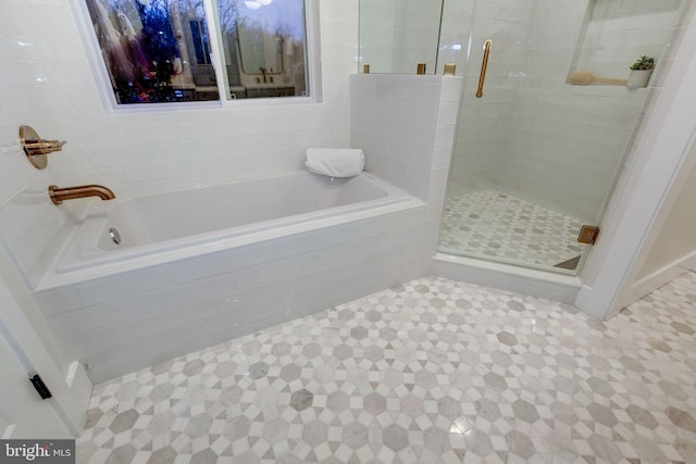 bathroom featuring independent shower and bath