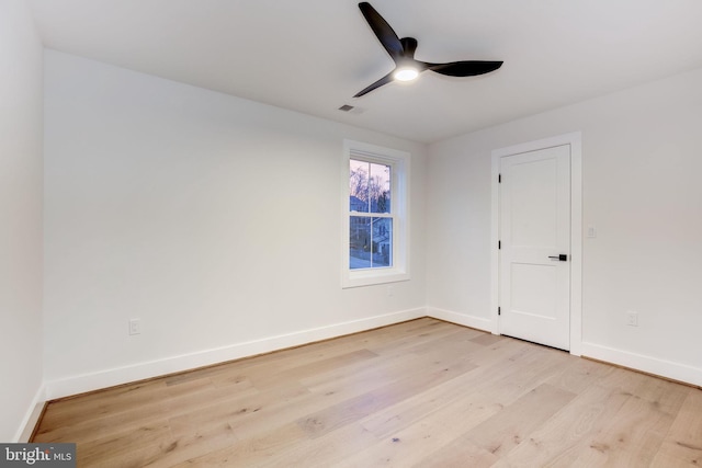 unfurnished room with ceiling fan and light wood-type flooring