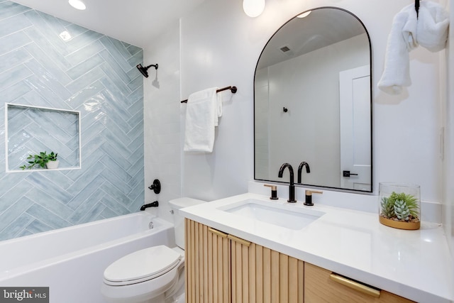 full bathroom with tiled shower / bath combo, vanity, and toilet