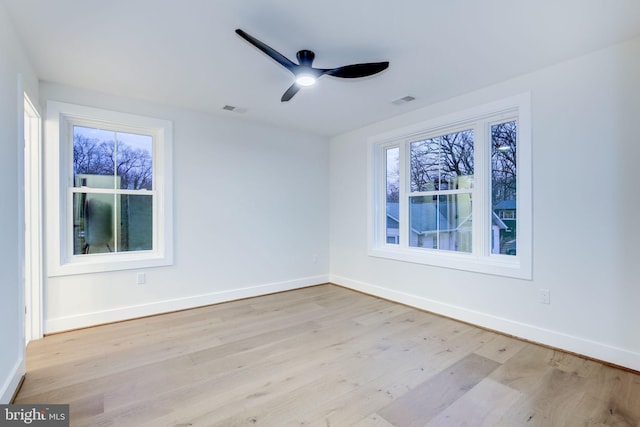 spare room with ceiling fan and light wood-type flooring