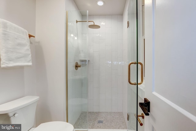 bathroom with walk in shower and toilet