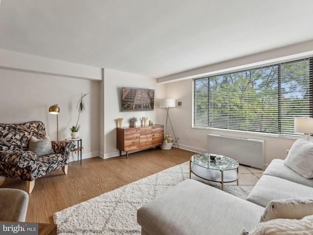 living room featuring light hardwood / wood-style floors and radiator heating unit