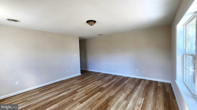 spare room with light hardwood / wood-style floors