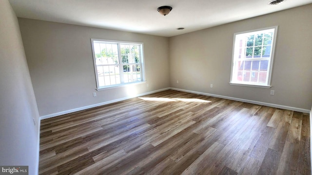 spare room with dark wood-type flooring