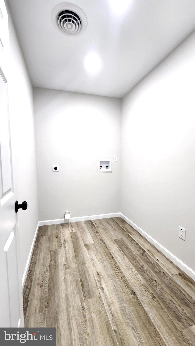 laundry room with washer hookup, electric dryer hookup, and wood-type flooring