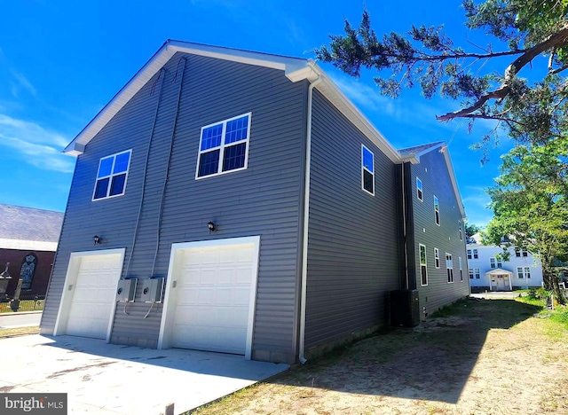 exterior space featuring cooling unit and a garage