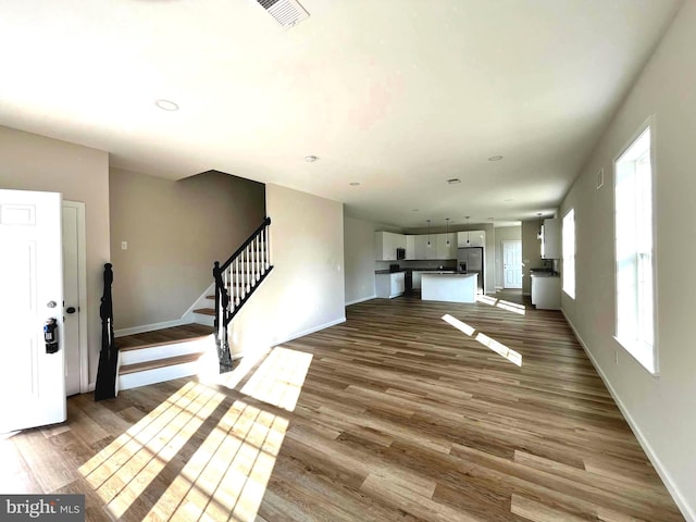 unfurnished living room featuring hardwood / wood-style floors