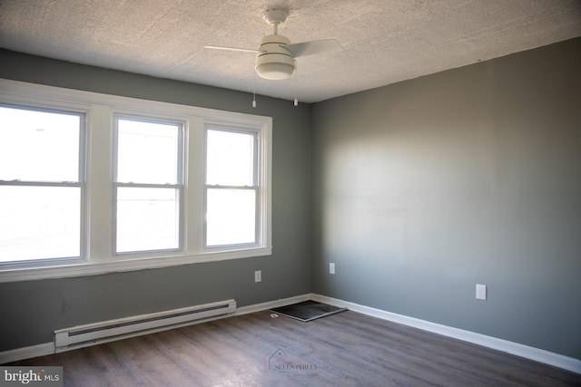 unfurnished room with a textured ceiling, baseboard heating, dark wood-type flooring, and ceiling fan