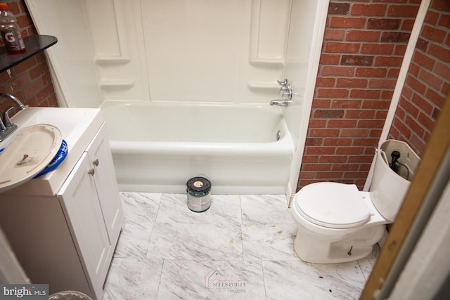 full bathroom featuring vanity, brick wall, bathtub / shower combination, and toilet