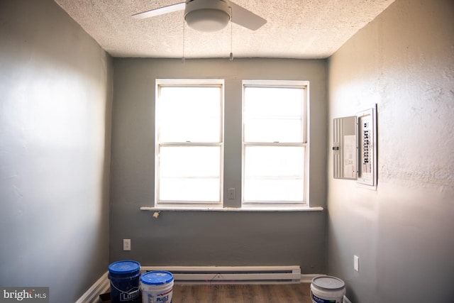 interior space with a textured ceiling, dark hardwood / wood-style floors, and ceiling fan