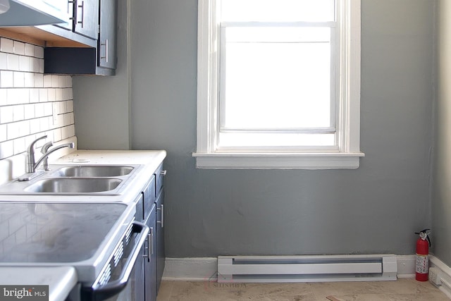 kitchen featuring decorative backsplash, sink, a baseboard radiator, and stove