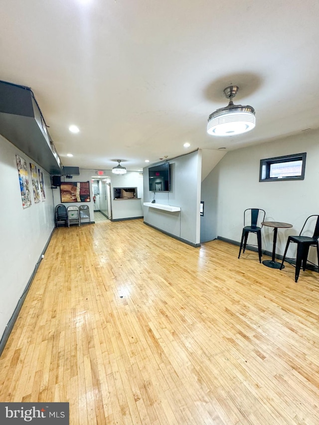 unfurnished living room featuring ceiling fan and light wood-type flooring