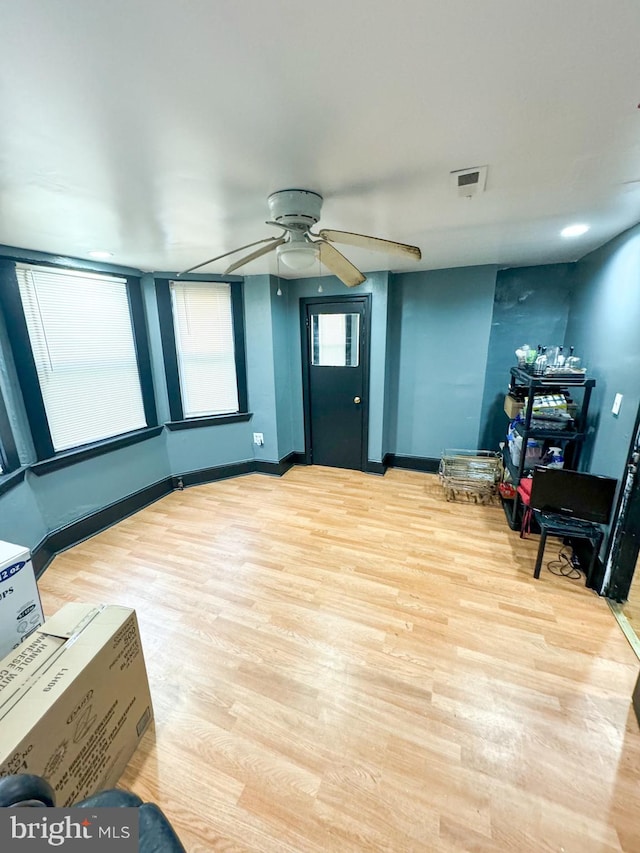 living area featuring ceiling fan and light wood-type flooring