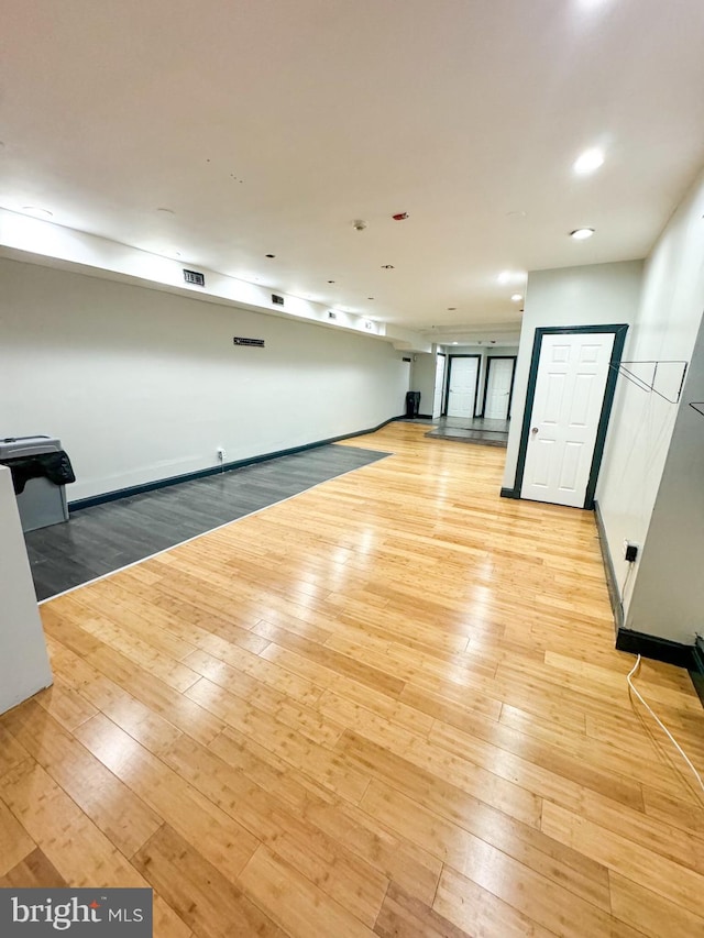 spare room featuring light wood-type flooring and basketball court