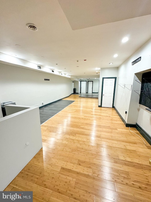 unfurnished room with light wood-type flooring