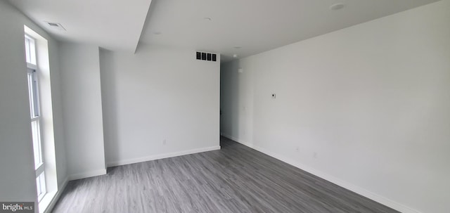 unfurnished room with wood-type flooring