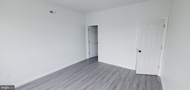 unfurnished room featuring hardwood / wood-style flooring